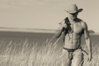 shirtless-sexy-cowboy-walking-in-a-field-in-New-Mexico.jpg